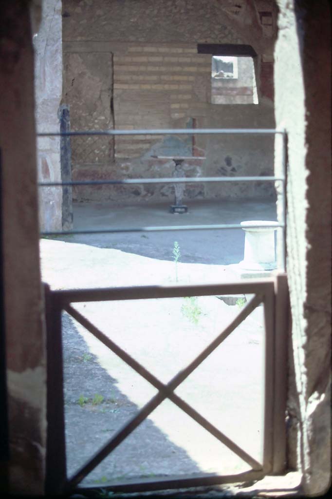 VI.16 Herculaneum. 7th August 1976.
Looking through doorway in south-west corner, linking to atrium of VI.17.
Photo courtesy of Rick Bauer, from Dr George Fay’s slides collection.